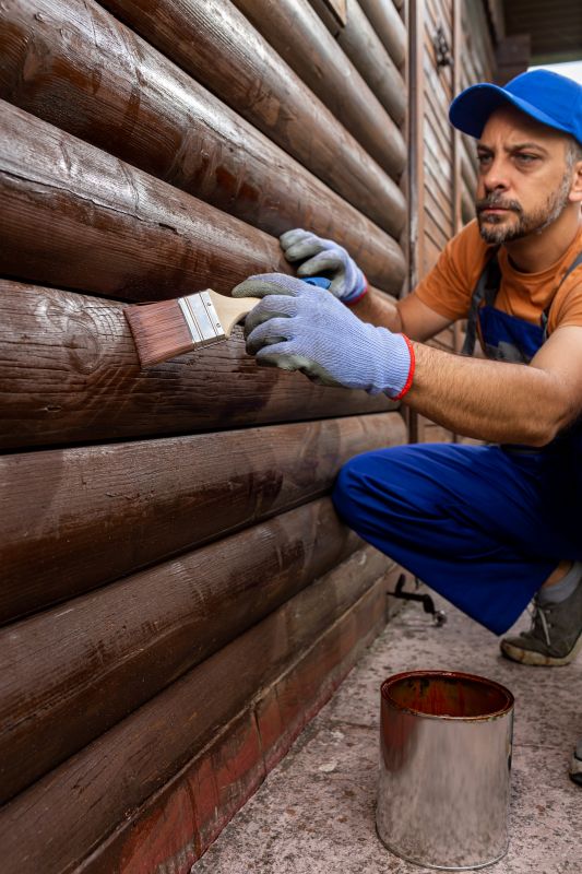 Siding being painted or stained