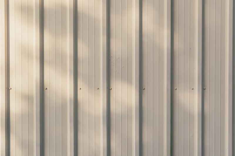Siding panels being aligned on a building
